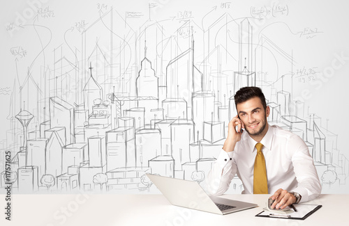 Businessman sitting at the white table with hand drawn buildings