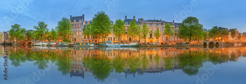 Photography Panoramic view and cityscape of Amsterdam with boats, old buildings and Amstel r