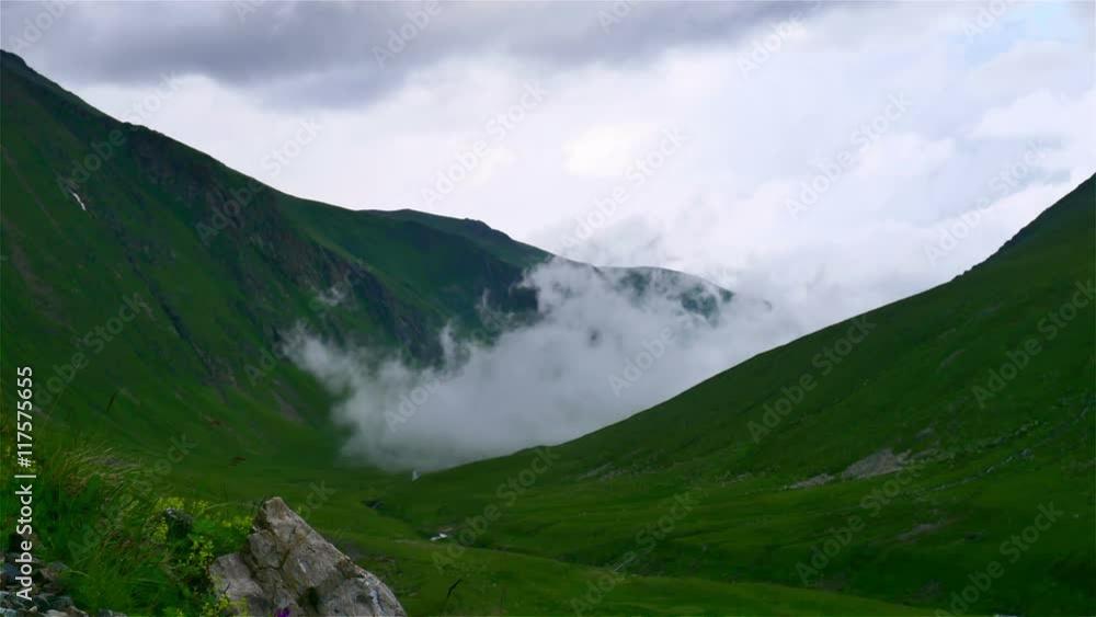 Time lapse of fog and clouds rolling over the mountain green valley in Kavkaz region Time lapse of fog and clouds rolling over the mountain green valley in Kavkaz region