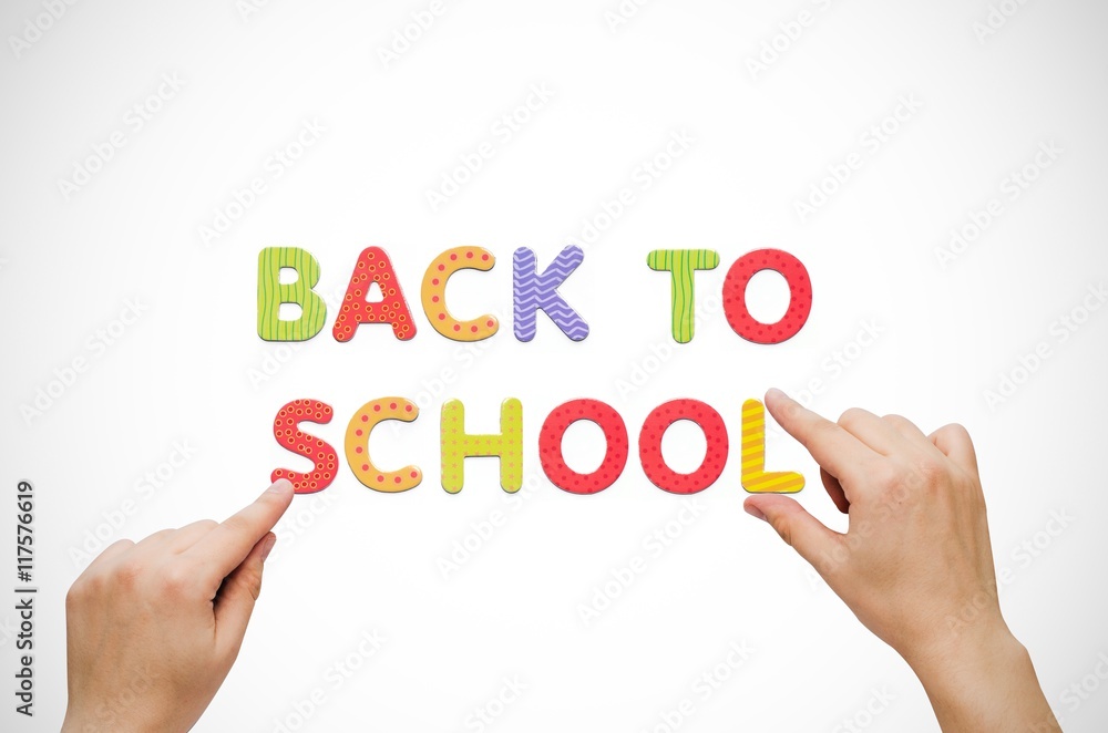 Hand put the words Back To School on magnetic board Hand put the words Back To School on magnetic board