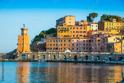 Sunset light illuminating the Lighthouse architecture of Rio Marina town - Elba island of Italy photo