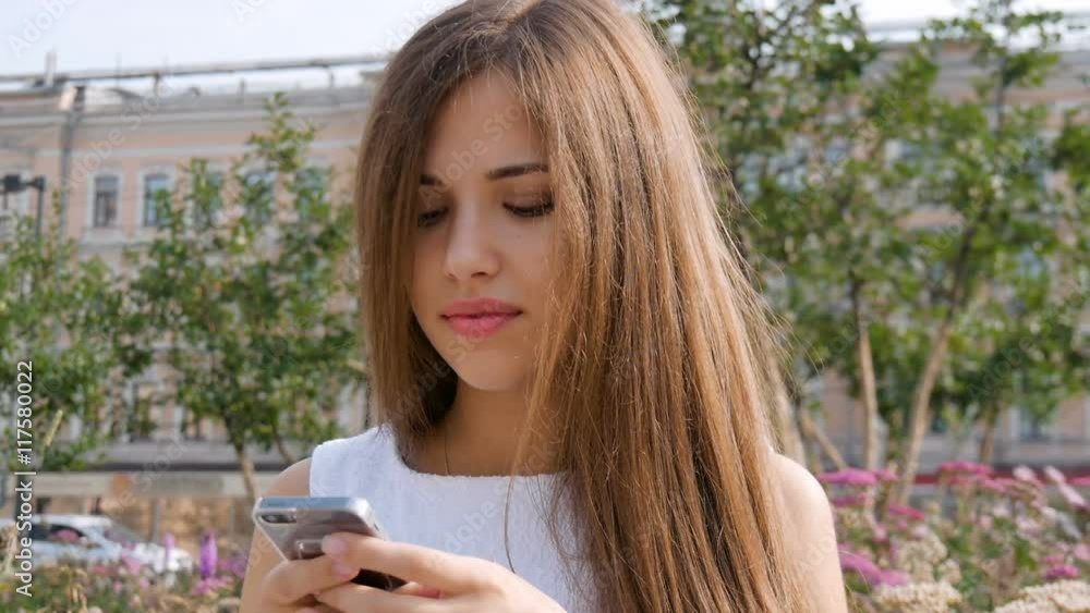 Attractive girl using mobile phone in a city. Attractive girl using mobile phone in a city.
