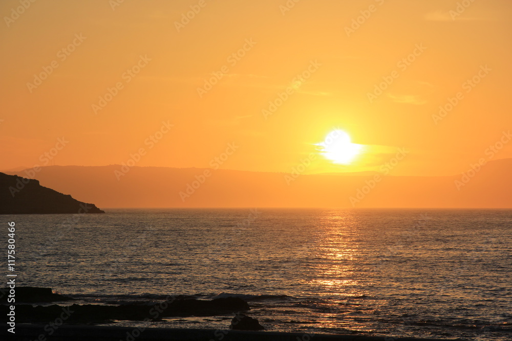 Bright orange sunset in the Mediterranean Sea in Greece