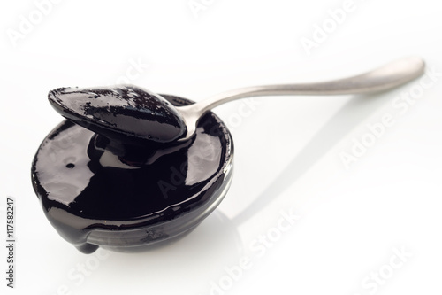 Vászonkép spoon with concentrated paste squid ink on white