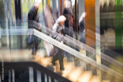People walking in modern interior, motion blur