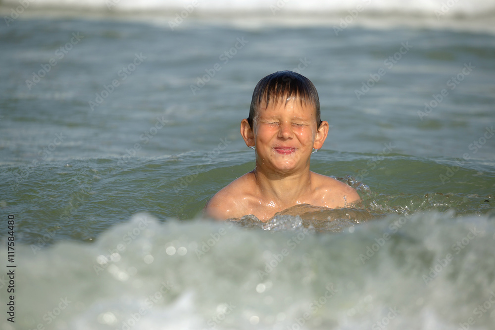 boy frolics in the sea with splashes and waves boy frolics in the sea with splashes and waves