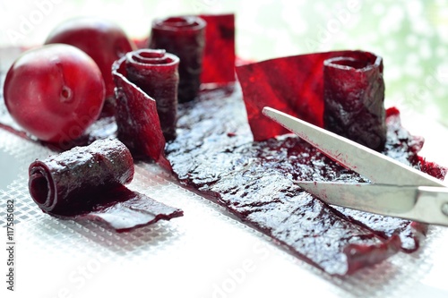 cutting with scissors homemade fruit leather of plums