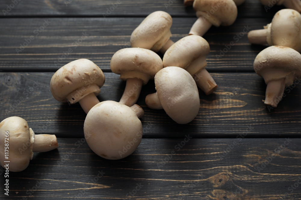 Fresh champignon mushrooms on wooden table Fresh champignon mushrooms on wooden table