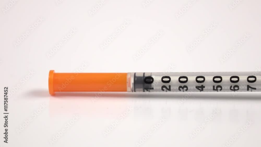 Insulin syringe on white, close up Insulin syringe on white, close up