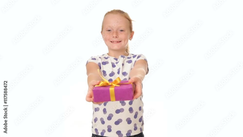 Little redhead girl giving a present ahead, white background Little redhead girl giving a present ahead, white background