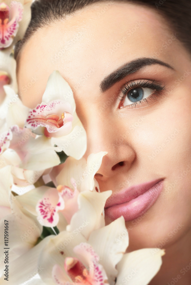 Pretty woman with orchid, closeup Pretty woman with orchid, closeup