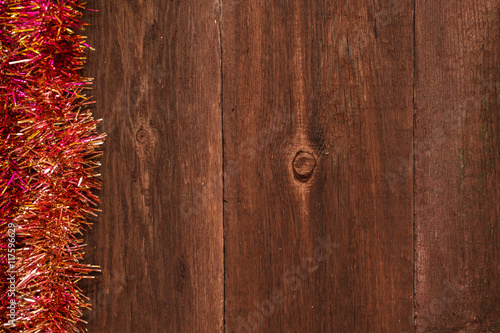 Christmas tinsel on a wooden background