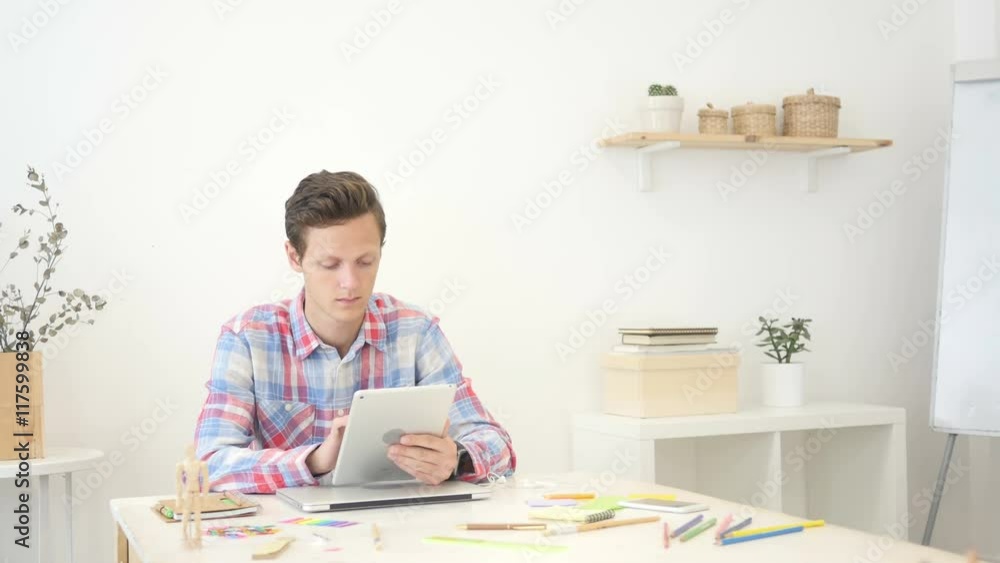 Young man / student , designer using tablet computer Young man / student , designer using tablet computer