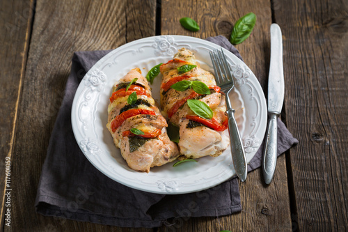 Baked chicken breast with mozzarella and cherry tomatoes with basil