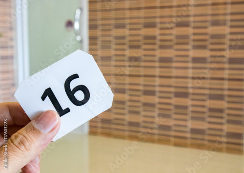 Hand hold queue number waiting at hospital, healthy concept photo