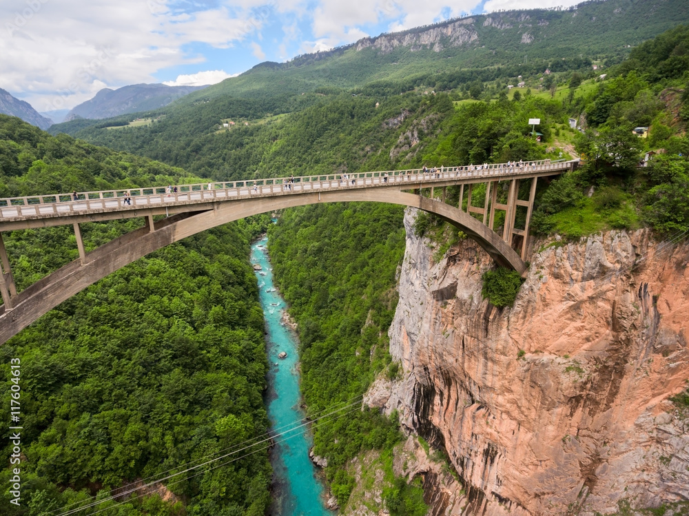 Durdevica bridge is concrete arch bridge over the Tara River in northern Montenegro. Side top view from flying drone Durdevica bridge is concrete arch bridge over the Tara River in northern Montenegro. Side top view from flying drone
