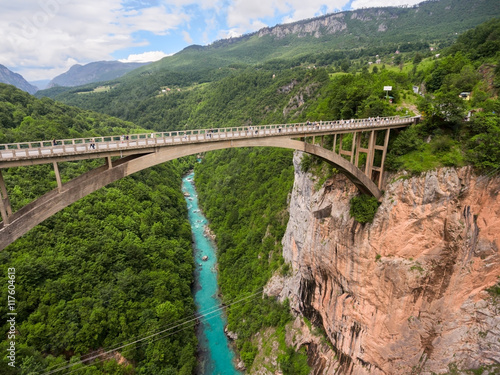 Durdevica bridge is concrete arch bridge over the Tara River in northern Montenegro. Side top view from flying drone