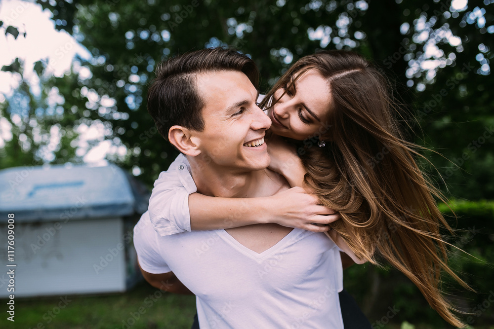 Young adult brunette man and woman in the park Young adult brunette man and woman in the park