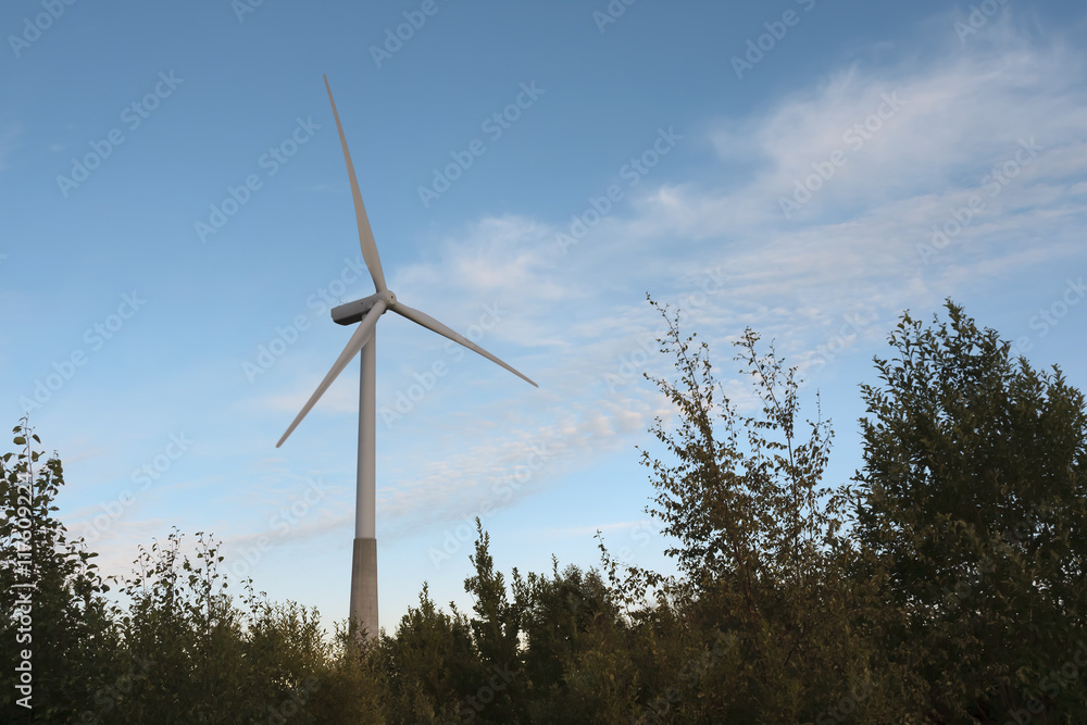 Windmill on rural field in the sunset. Wind turbines farm. Toning photo. Windmill on rural field in the sunset. Wind turbines farm. Toning photo.