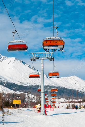  Chairlift on background of snowy mountains in the High Tatras