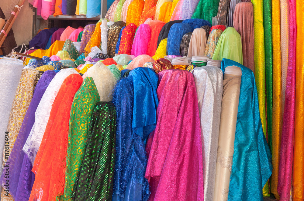 Rolls of brightly coloured fabrics and cloths