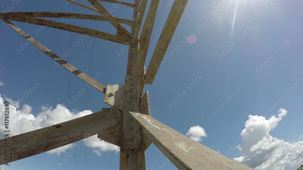 Fragment electrical pylon against blue cloudy sky, time lapse 4K Fragment electrical pylon against blue cloudy sky, time lapse 4K