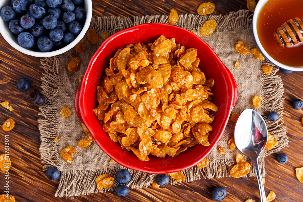Corn Flakes with berries raspberries, blueberries, glass of milk, and sweet honey. Corn Flakes with berries raspberries, blueberries, glass of milk, and sweet honey.
