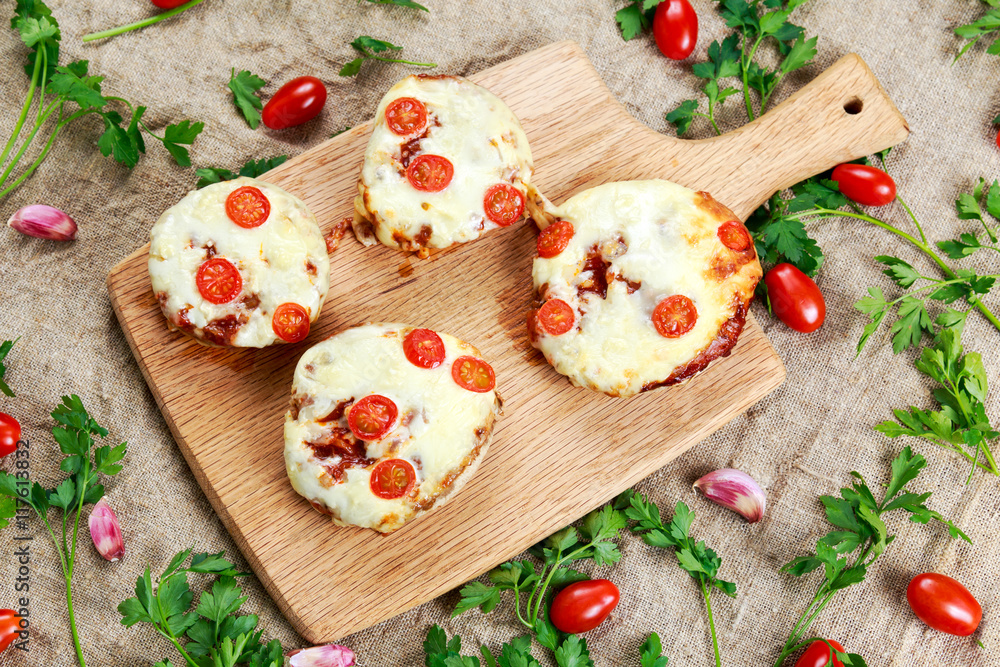 Cooked Mushrooms stuffed with cheese and plum tomatoes.