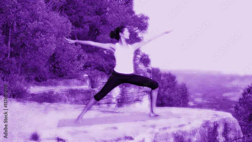 woman practices yoga clifftop setting at sunset woman practices yoga clifftop setting at sunset