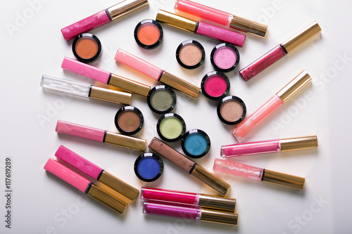 Make-up eye shadows with lip gloss. View from above. Flat lay