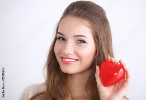 Beautiful woman hold red heart.
