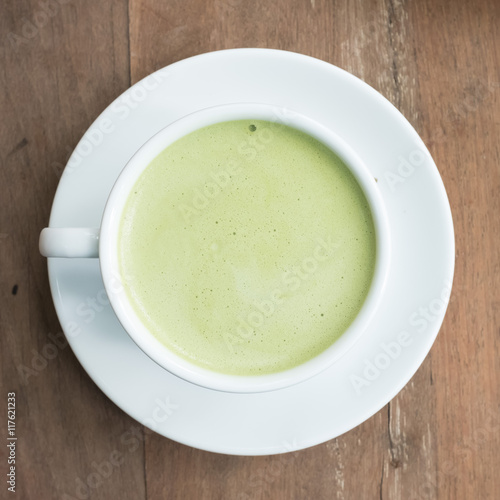 green tea latte on wood background