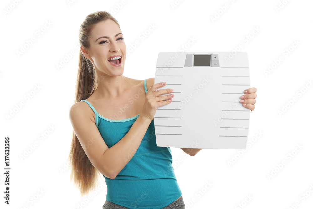 Beautiful young woman holding floor scales on white background Beautiful young woman holding floor scales on white background