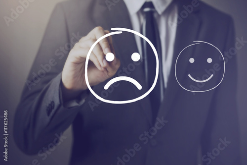 Customer choosing to write unhappy face over happy face
