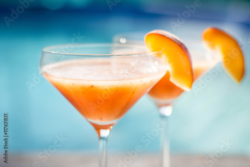 Obraz na płótnie Bellini cocktail with peach isolated near pool w salonie