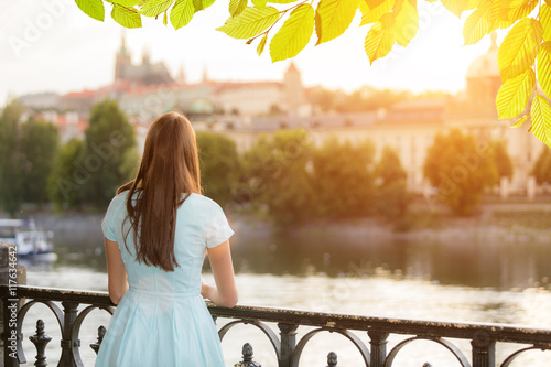 Photography Brunette girl watching old town center