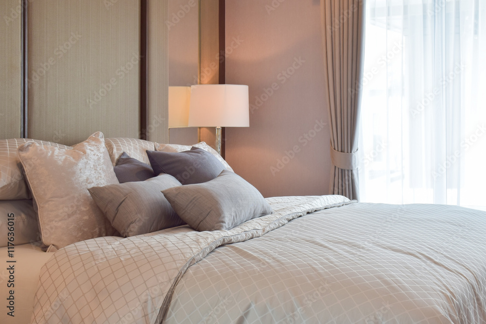 Classic bedroom interior with pillows and reading lamp on bedside table Classic bedroom interior with pillows and reading lamp on bedside table