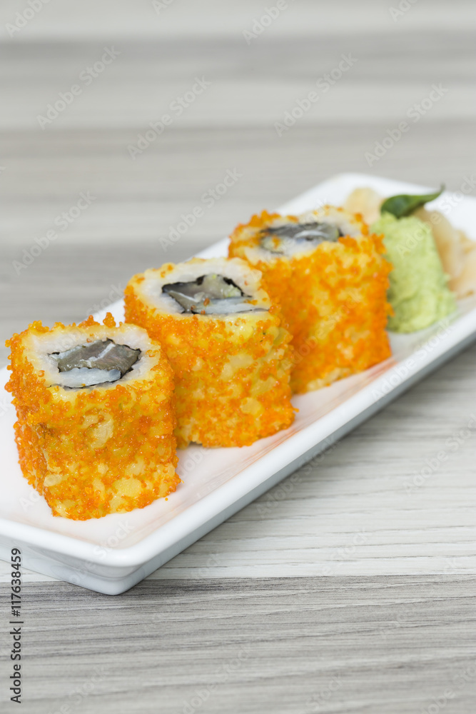 Sushi rolls with shrimps eggs and seaweed on a dish Sushi rolls with shrimps eggs and seaweed on a dish