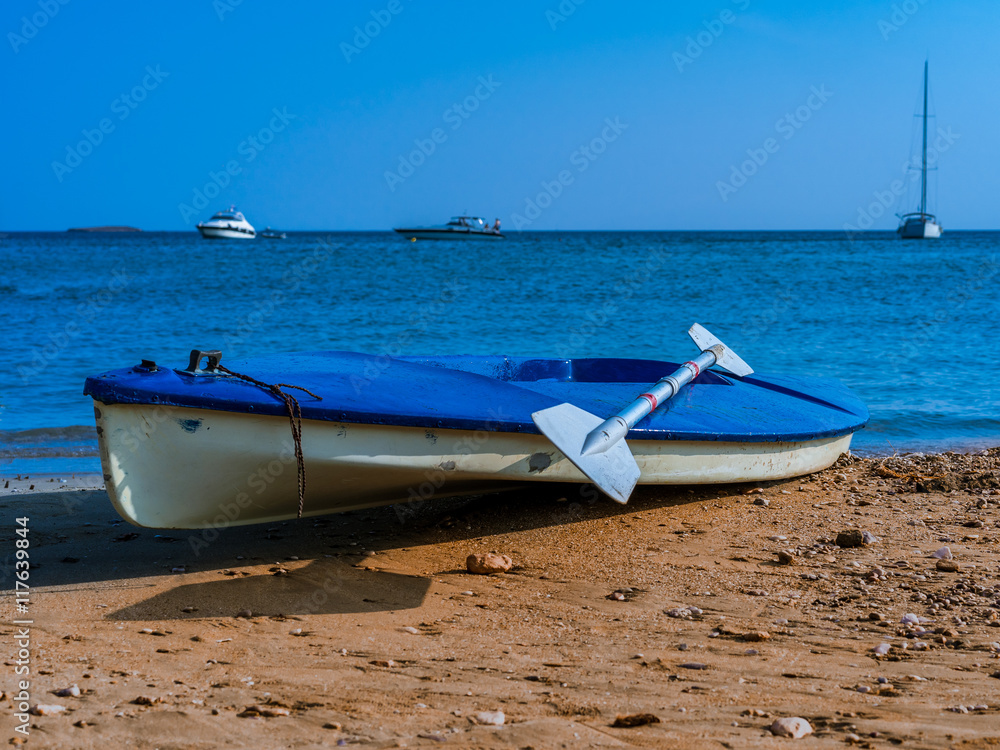 canoe kayak, canoe with oar and yachts in the background on the coast of the Mediterranean Sea. Water Sports. beautiful landscape.small boat with oars canoe kayak, canoe with oar and yachts in the background on the coast of the Mediterranean Sea. Water Sports. beautiful landscape.small boat with oars