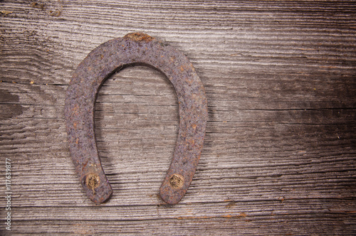 Old horseshoe on a wooden table, top view