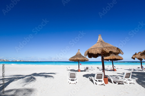 Beach chairs and sun umbrellas on a stunning tourist resort coas
