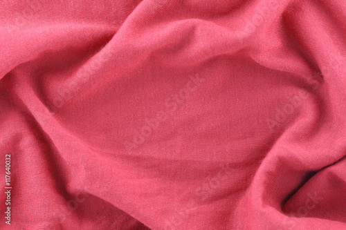 Closeup of rippled red cotton fabric.