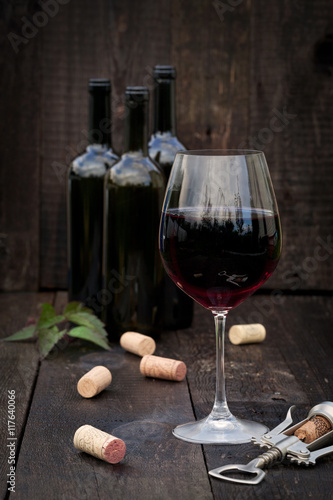 Glass of red wine on old wooden table