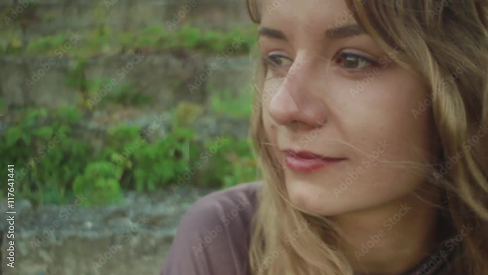Beautiful girl sitting on stone steps and crying close-up Beautiful girl sitting on stone steps and crying close-up