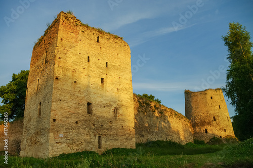 A view of the medieval Izborsk fortress walls and towers in sunset, Pskov region,Russia