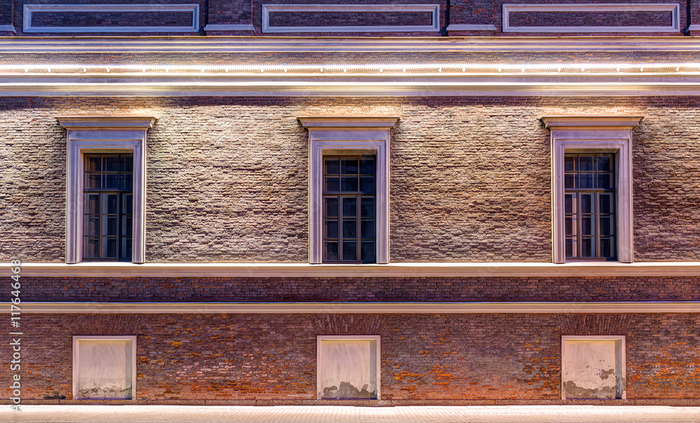 Several windows in a row on night illuminated facade of Central Naval Museum front view, St. Petersburg, Russia.
