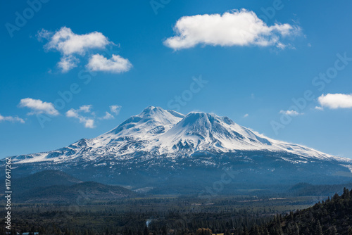 Snowcapped Mount Shasta volcano during winter with valley view