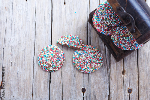 Top view of chocolate freckles on a wooden background.