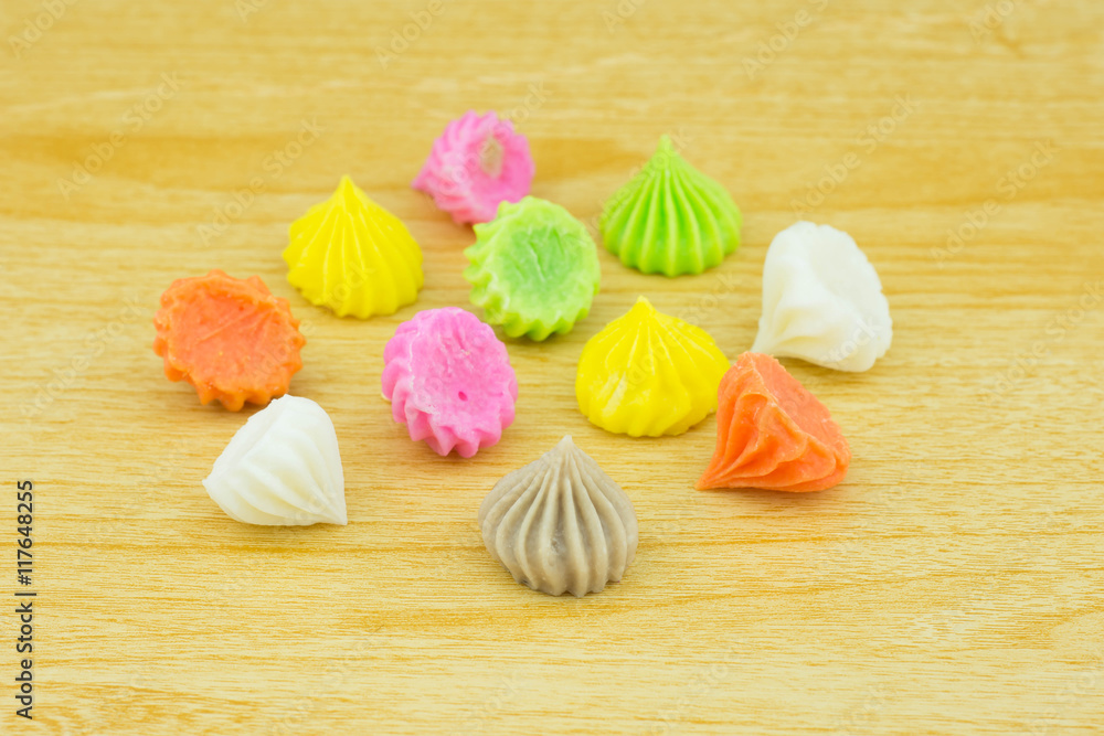 Aalaw candy, colorful Thai dessert on wood background Aalaw candy, colorful Thai dessert on wood background