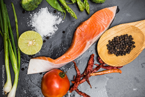 Flatlay of Healthy seafood concept salmon fillet with fresh ingr photo